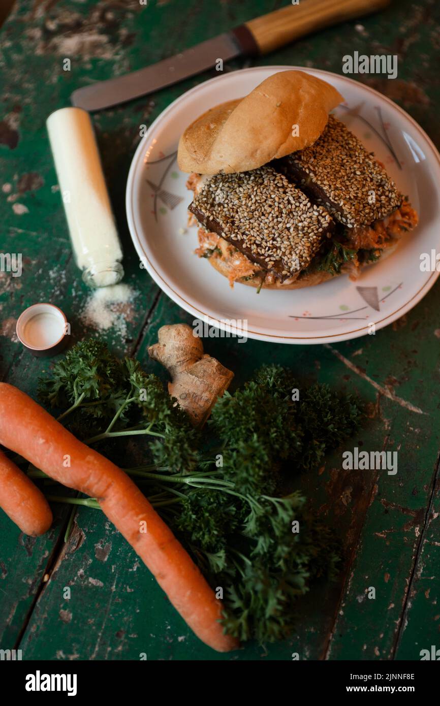 Vegan tofu burger with sesame seeds, carrot, ginger, parsley and salt Stock Photo