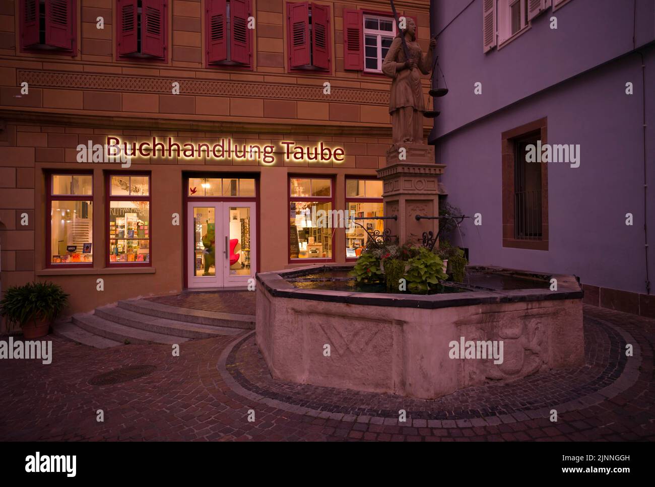 Justitia fountain, behind it bookshop Taube, market place, evening mood, Waiblingen, Baden-Wuerttemberg, Germany Stock Photo