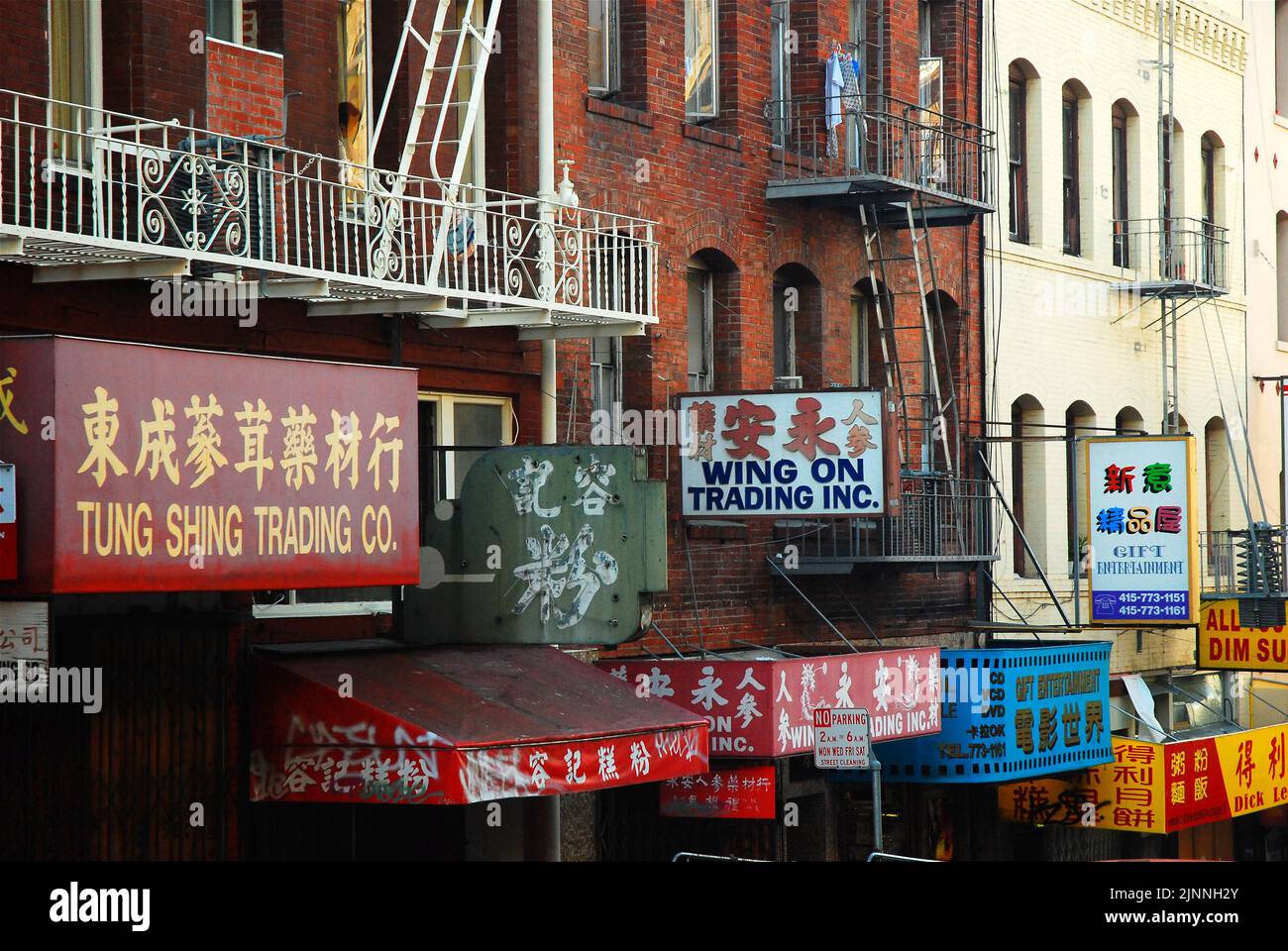 Signs abound for the many unique and small businesses crowd together in the buildings of San Francisco's Chinatown Stock Photo