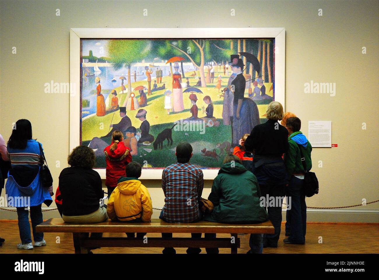 Museum Patrons admire the Georges Seurat masterpiece A Sunday Afternoon on the Island of La Grande Jatte at the Art Institute of Chicago Stock Photo
