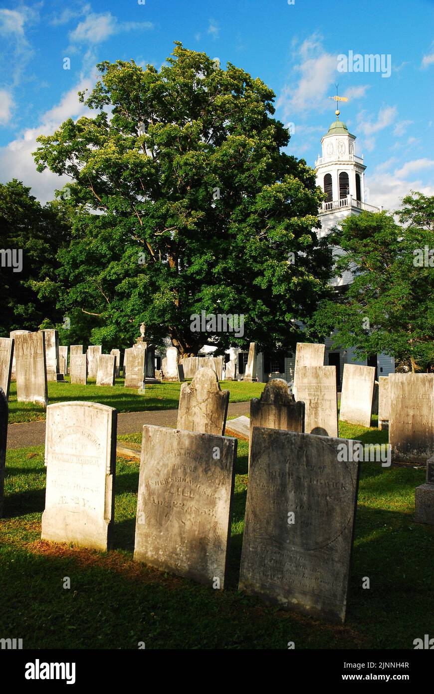 A historic graveyard stands on the grounds of the Church on the Hill, a small Christian church in Lenox Massachusetts Stock Photo