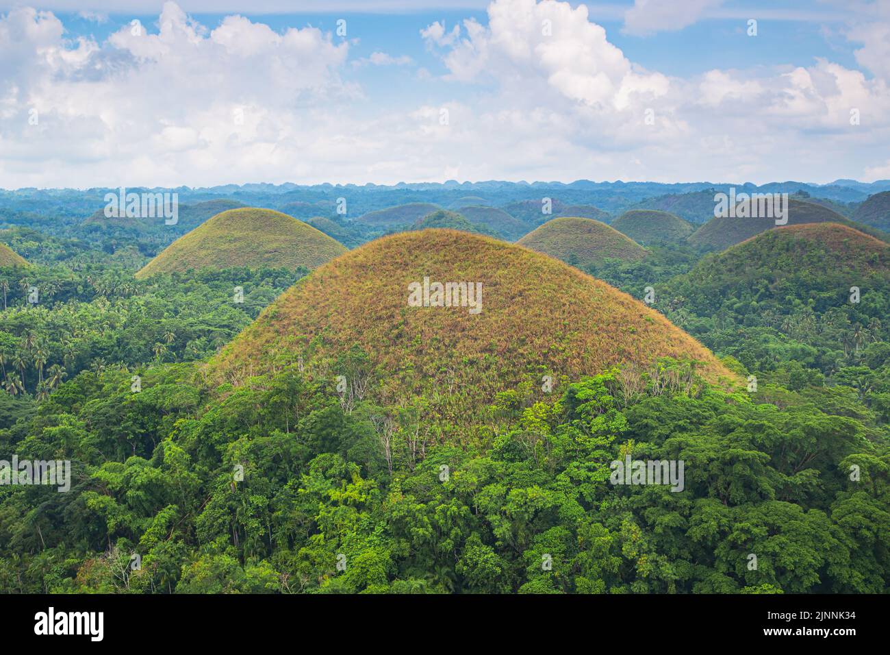 Brown color of chocolate hills, blue sky, and clouds in Bohol island