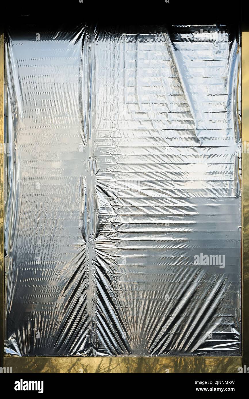 Wrinkled foil film covering the window untight Stock Photo Alamy