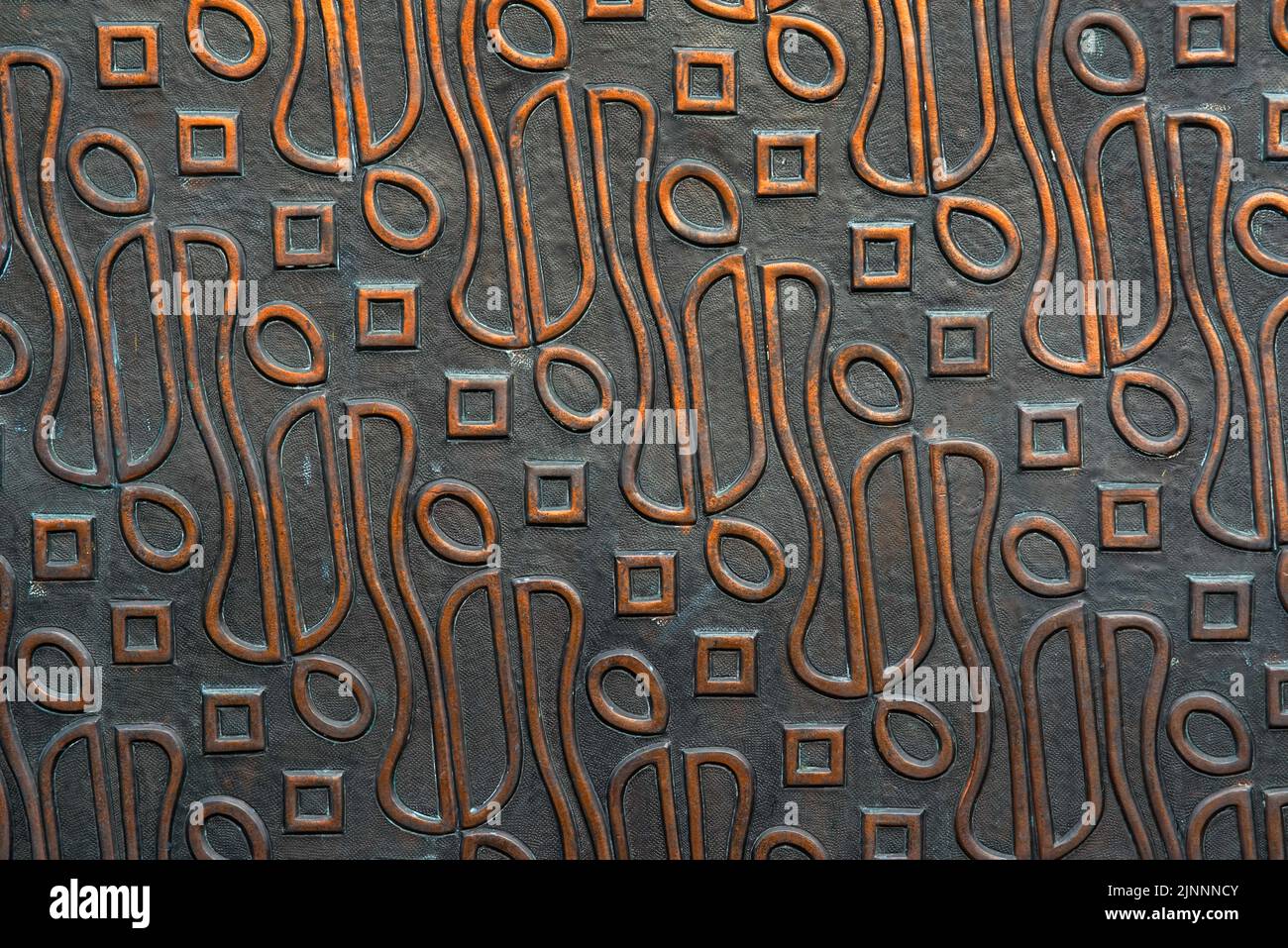 Traditional indonesian batik textured on steel. wall of steel is carved with batik motif. batik on metal plate surface. Stock Photo