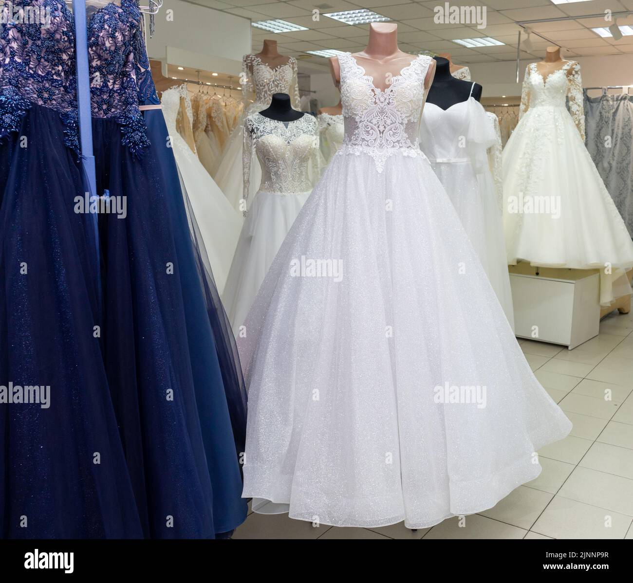 Many different wedding dresses in the bridal shop Stock Photo