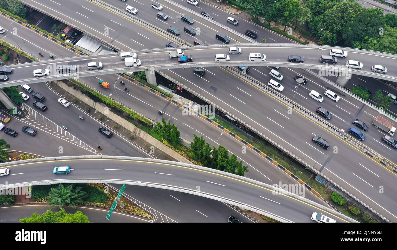 Aerial drone bird's eye view photo of latest technology cross shape multi level road highway passing through city center Stock Photo