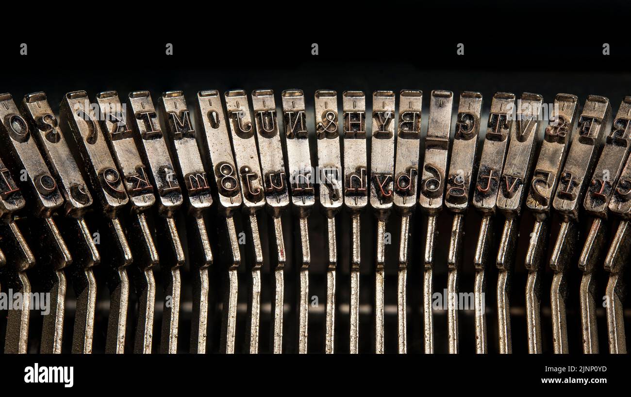 Closeup view of vintage typewriter keys in revers with visible ink. Stock Photo