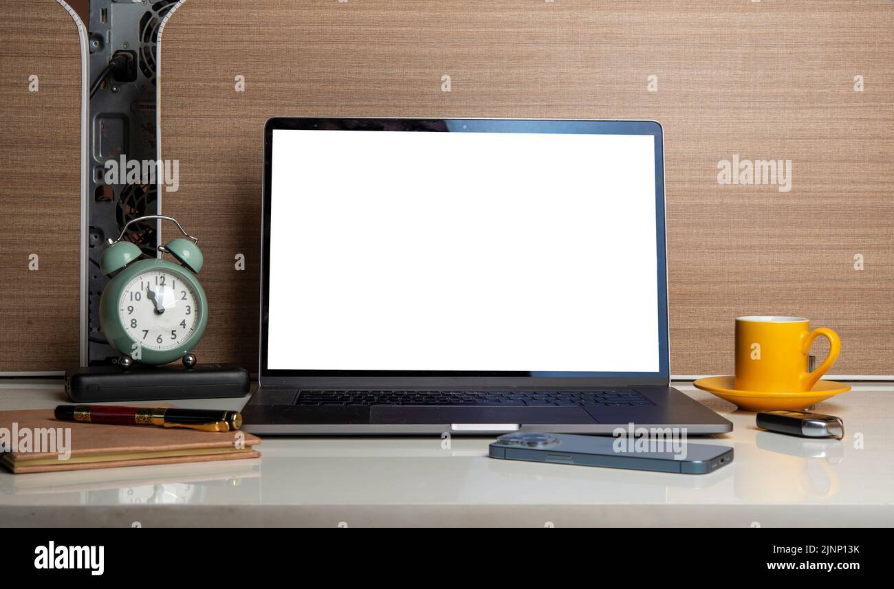 View of office desk with laptop screen and office items - mockup with free copy space. Stock Photo