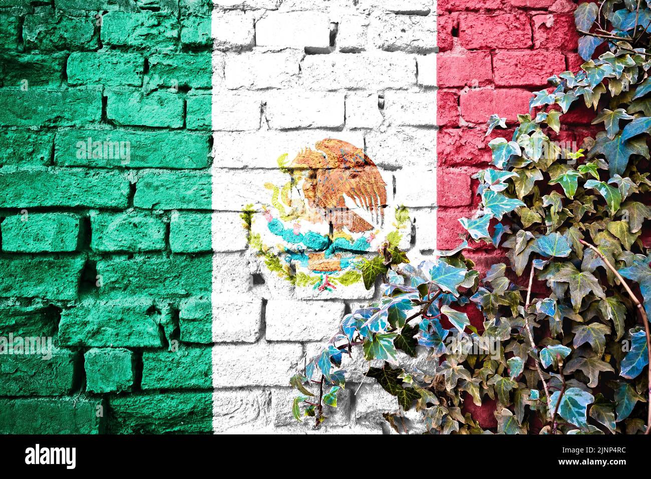 Mexico grunge flag on brick wall with ivy plant, country symbol concept Stock Photo