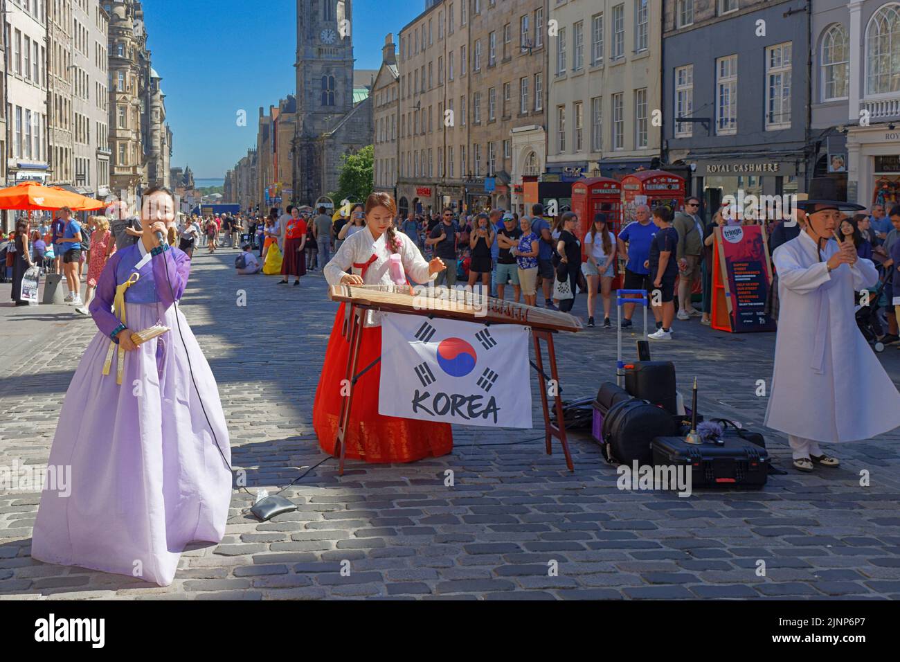 Edinburgh, Scotland, August 11, 2022 Festival Fringe Royal Mile two Korean musicians with lady singer in traditional dress playing their  instruments Stock Photo