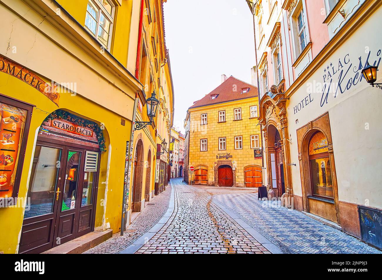PRAGUE, CZECH REPUBLIC - MARCH 6, 2022:  The narrow curved Karlova Street, lined with medieval houses, hotels, restaurants, on March 6 in Prague Stock Photo