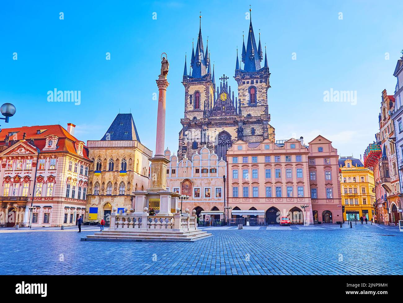The stone Marian Column in front of historic houses of Old Town Square - National Gallery, Stone Bell House and Our Lady before Tyn Church, Stare Mest Stock Photo
