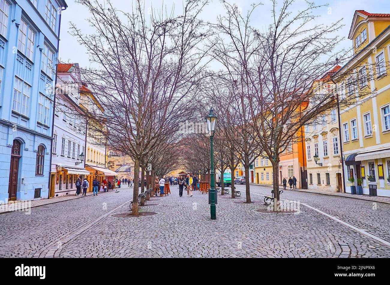 PRAGUE, CZECH REPUBLIC - MARCH 6, 2022: Na Kampe Street with tall trees, pedestrian alleys and historic houses, Lesser Quarter, on March 6 in Prague Stock Photo