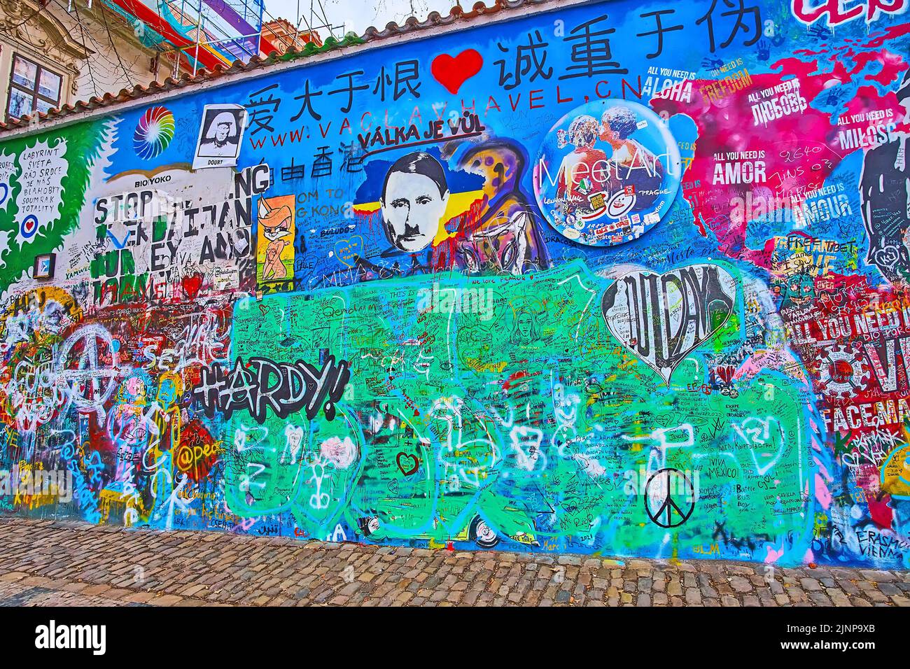 PRAGUE, CZECH REPUBLIC - MARCH 6, 2022: The graffiti, designs, slogans of Lennon Wall memorial, Velkoprevorske (Grand Priory) Square of Lesser Quarter Stock Photo
