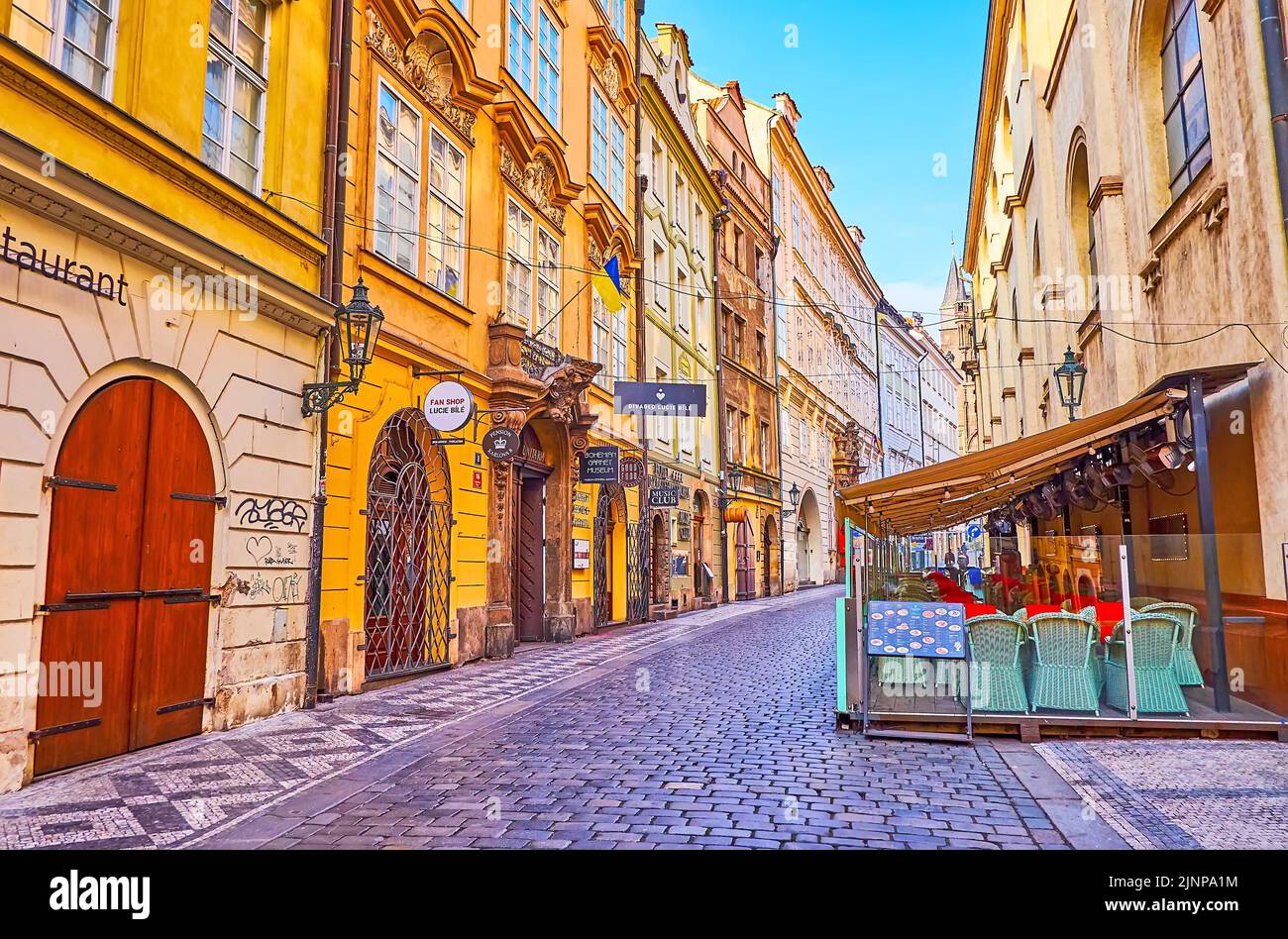 PRAGUE, CZECH REPUBLIC - MARCH 6, 2022:  Karlova Street with line of small tourist restaurants and shops in historic townhouses, on March 6 in Prague Stock Photo