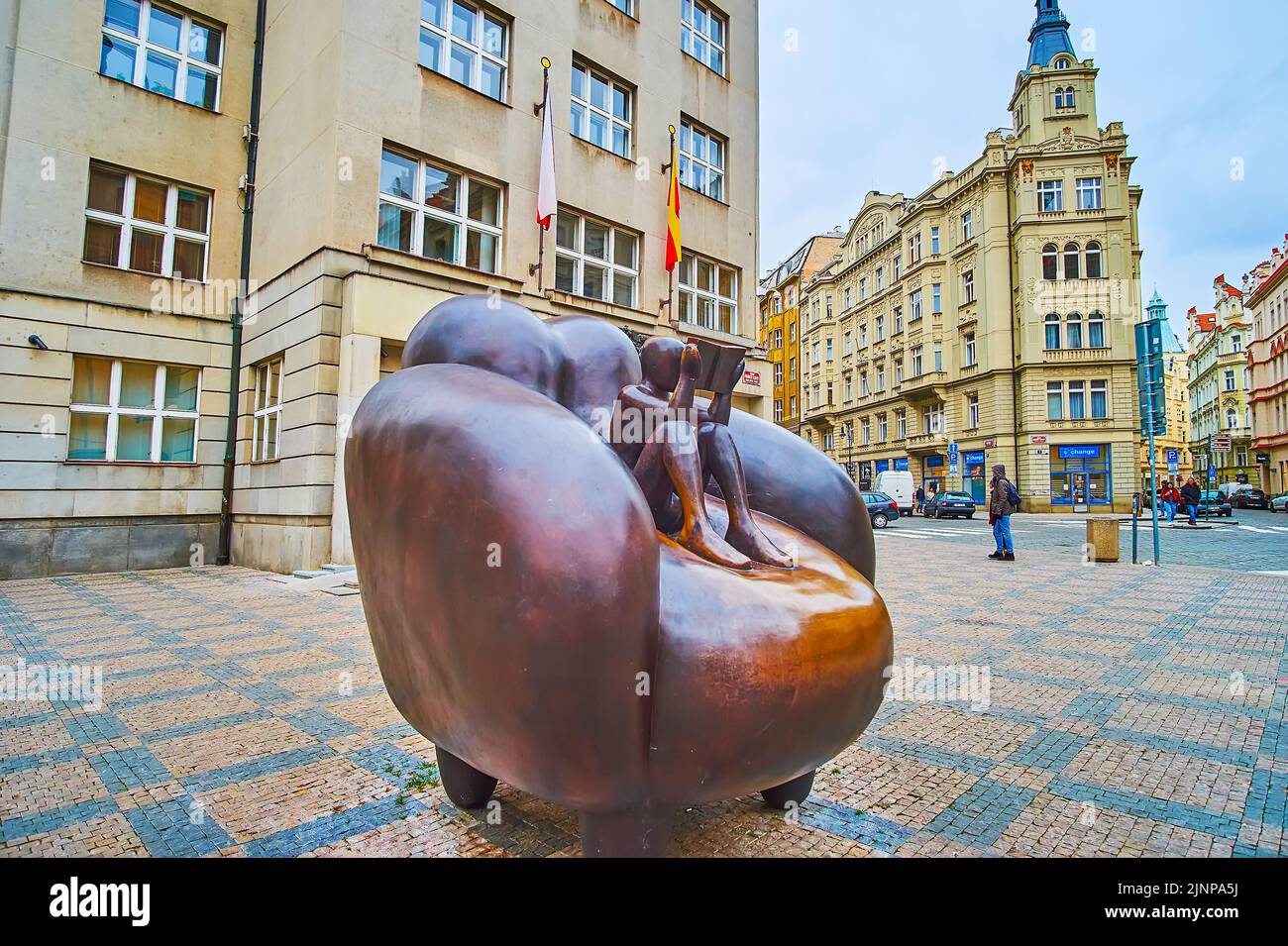 PRAGUE, CZECH REPUBLIC - MARCH 6, 2022: The modern statue by Jaroslav Rona, named the Reader in an armchair, located on Franz Kafka Square, on March 6 Stock Photo