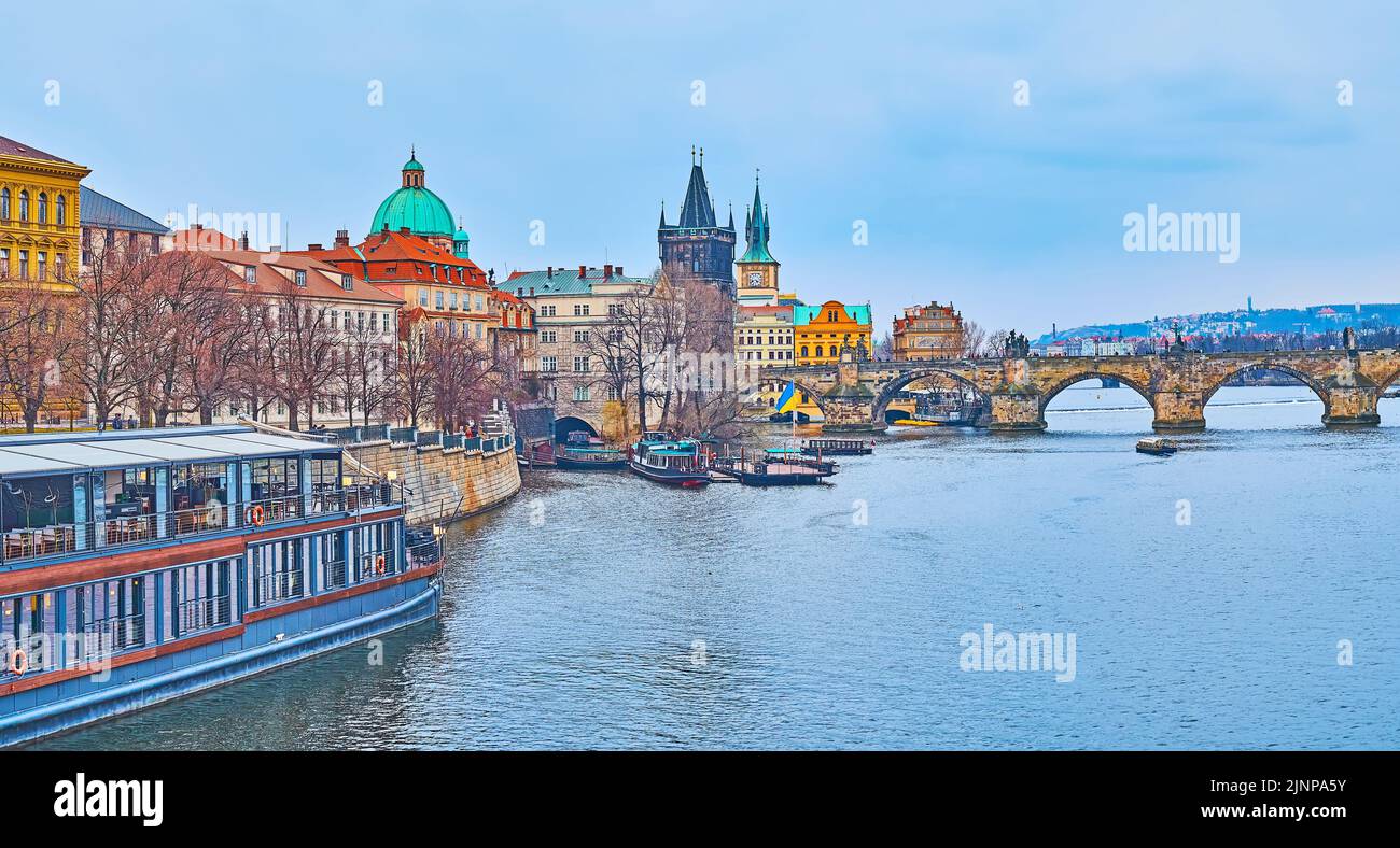 Embankment of Vltava River with Old Town housing and Charles Bridge with Gothic Old Town Bridge Tower, Prague, Czech Republic Stock Photo