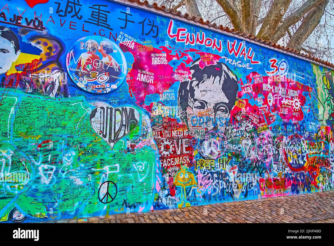 PRAGUE, CZECH REPUBLIC - MARCH 6, 2022: The brightly decorated portion of Lennon Wall memorial, Velkoprevorske (Grand Priory) Square of Lesser Quarter Stock Photo