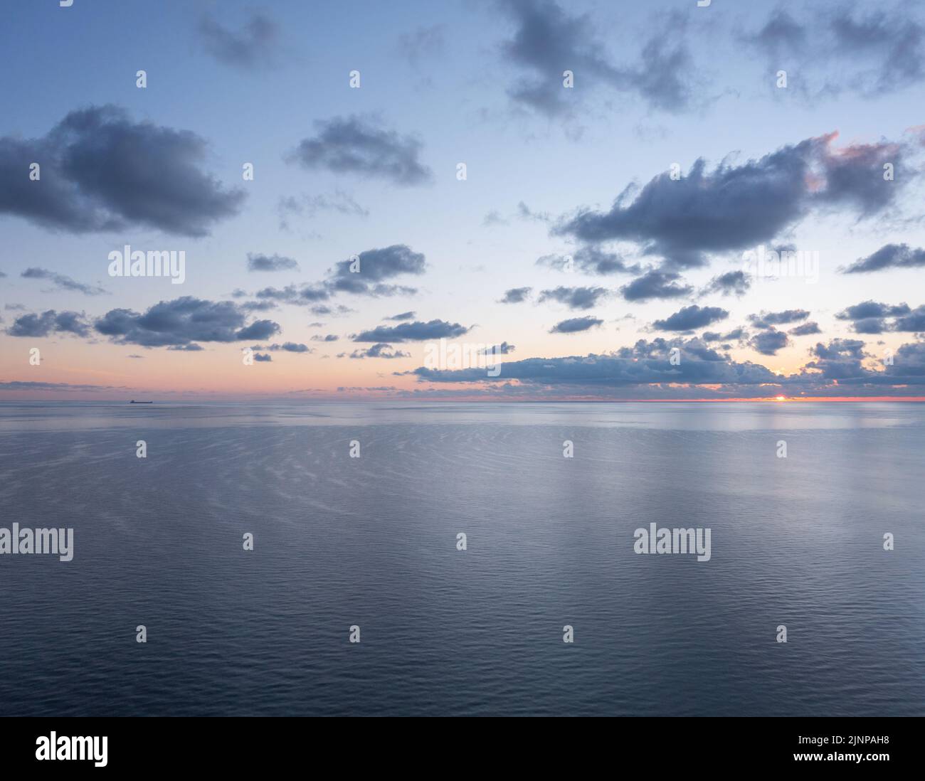 Panoramic view of the calm sunrise over the ocean with copy space Stock Photo