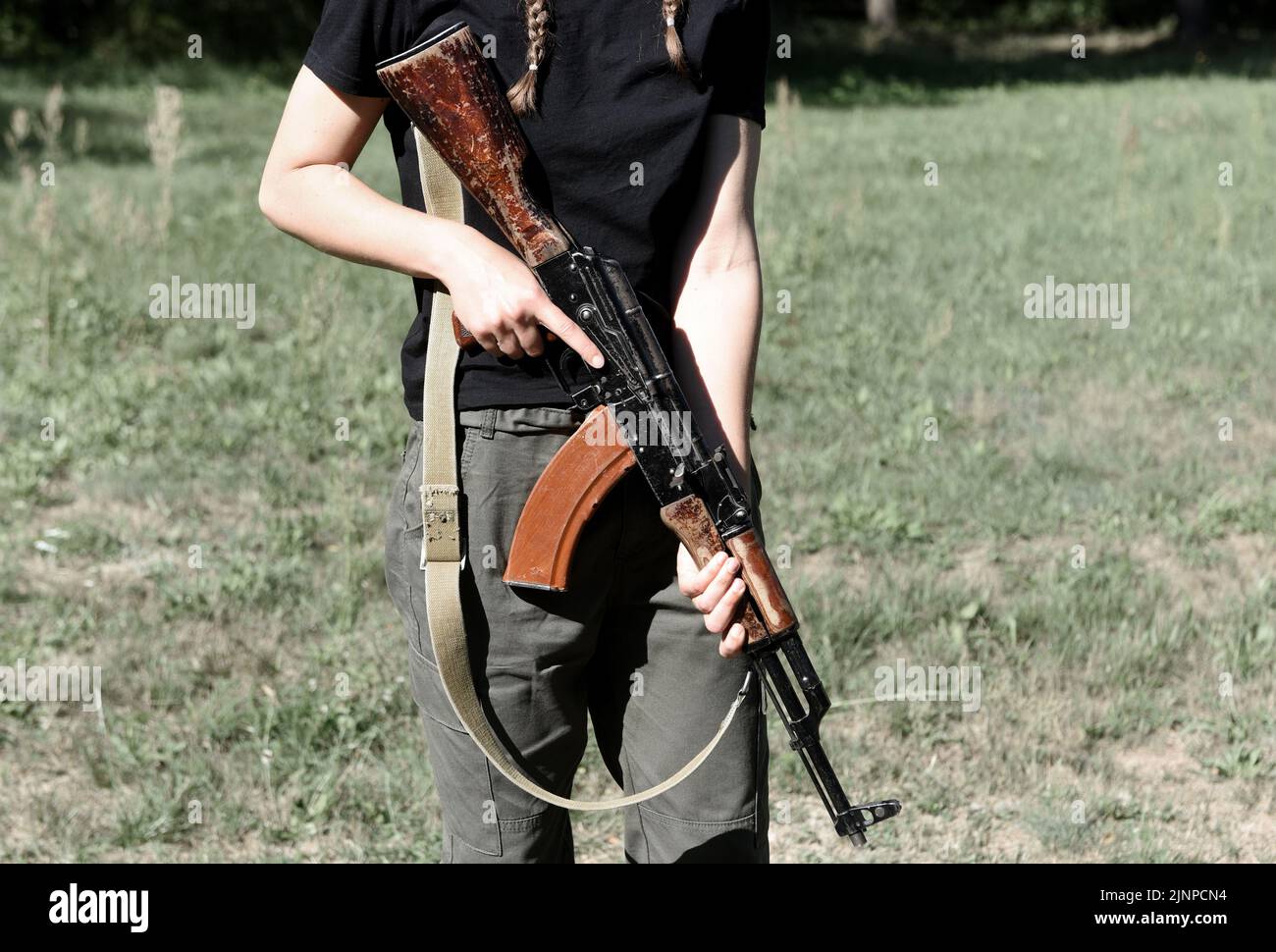 Woman with AK assault rifle. Tactical exercises. War in Ukraine Stock Photo