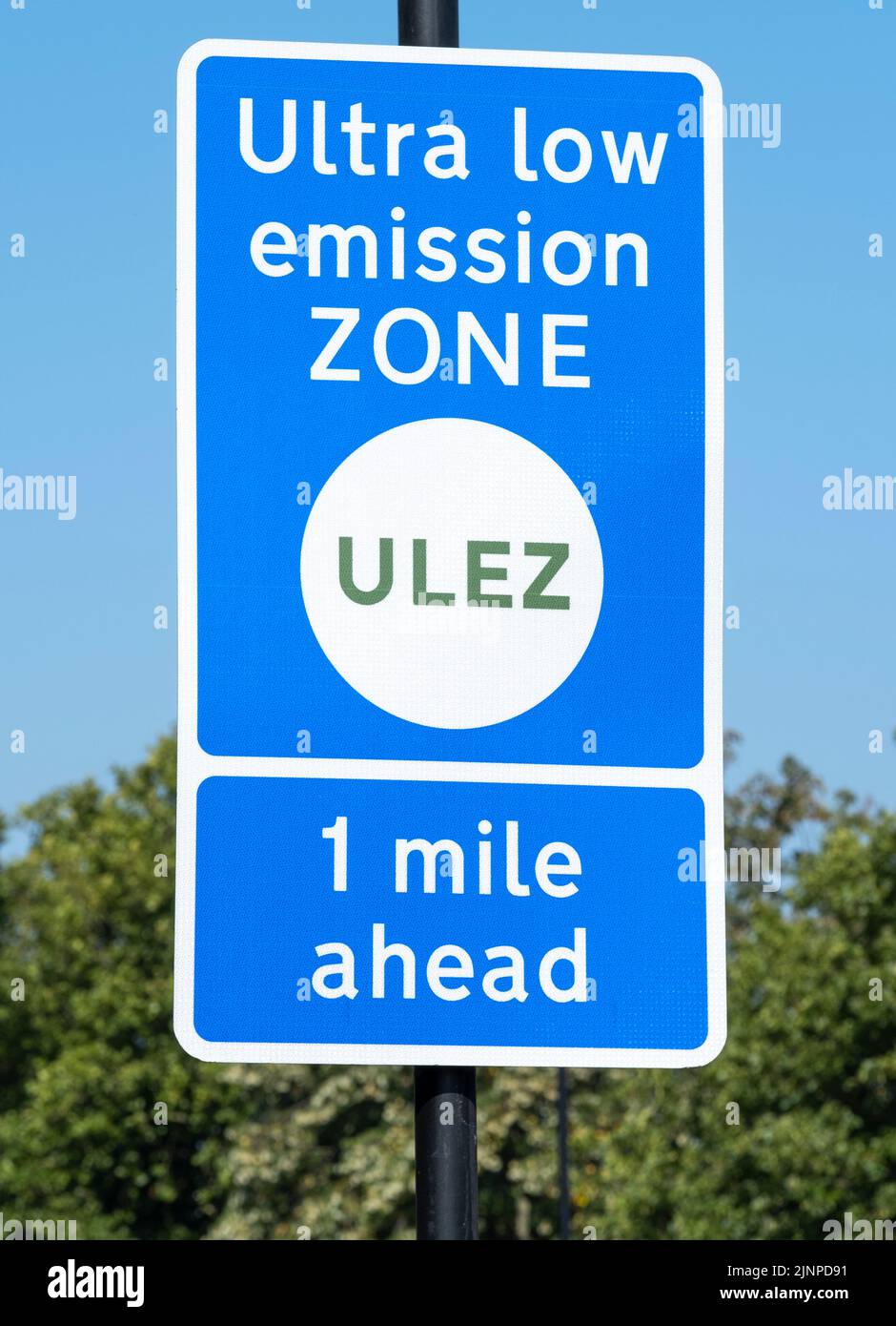 Close up of ULTRA LOW EMISSION ZONE sign against a clear blue sky. Stock Photo