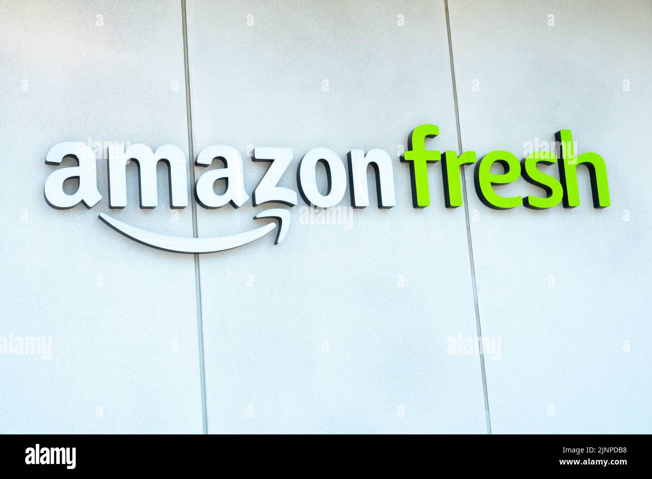 Canary Wharf, London, UK.  Low angle view of Amazon Fresh brand logo on building exterior located at Canary Wharf. Stock Photo