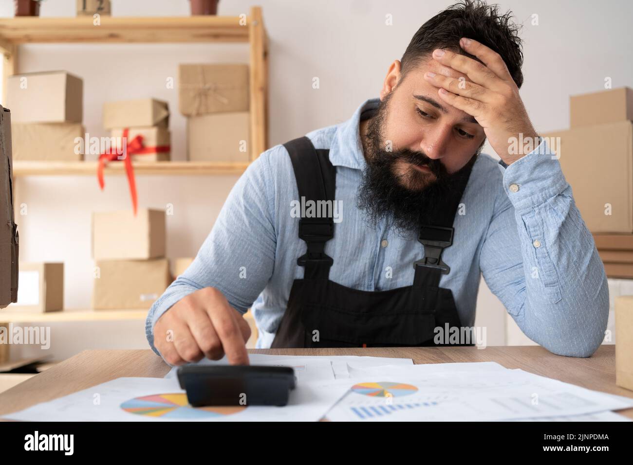 Indian entrepreneur doing cost analysis for small business, accountant