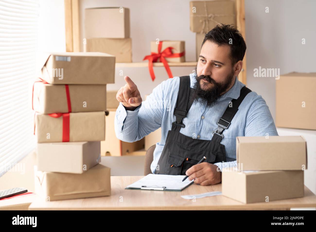 Entrepreneurs Small Business SME Independent Indian men work at home, commercial checking cardboard box, online marketing, packing boxes, SME sellers Stock Photo