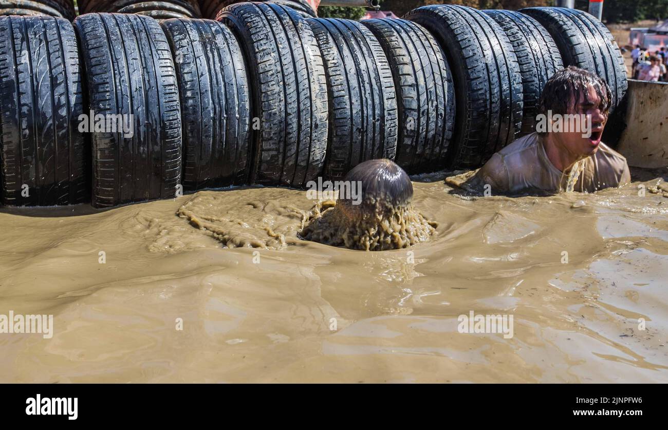 London UK 13 August 2021  Great fun and hard work, with the electroshock therapy and the muddy water obstacle been the favourite one. Paul Quezada-Neiman/Alamy Live News Stock Photo