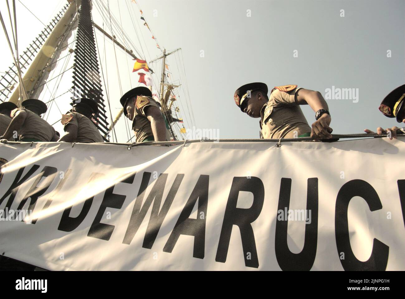 Indonesian navy cadets walking up the ladder of KRI Dewaruci (Dewa Ruci), an Indonesian tall ship, as the barquentine type schooner is opened for public visitors at Kolinlamil harbour (Navy harbour) in Tanjung Priok, North Jakarta, Jakarta, Indonesia. Stock Photo