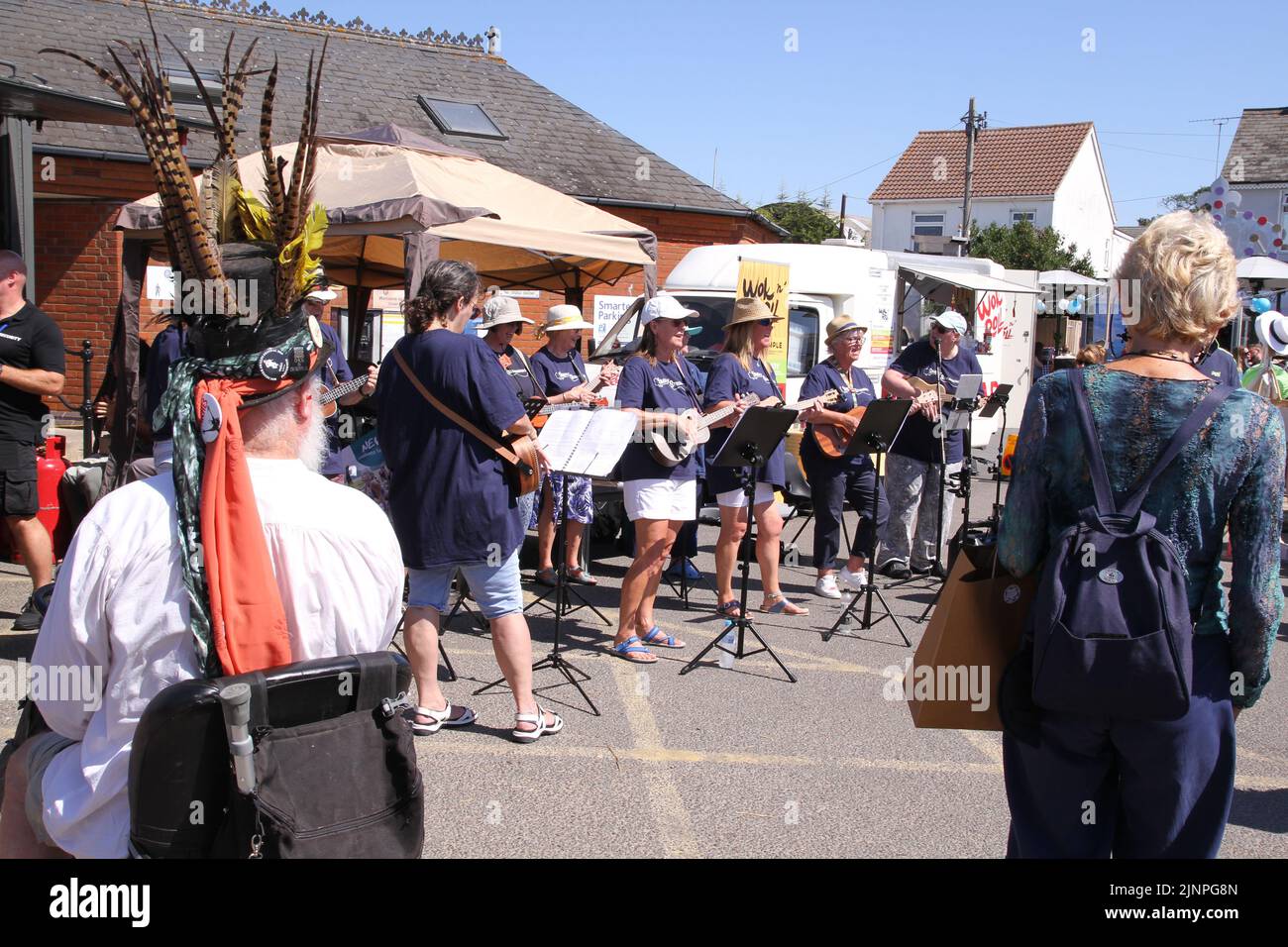 West Mersea Regatta is taking place on Mersea Island. The regatta has been run almost continually since 1838 and is organised by volunteers. Simply Strummers ukulele and guitar band entertain the crowd. Stock Photo