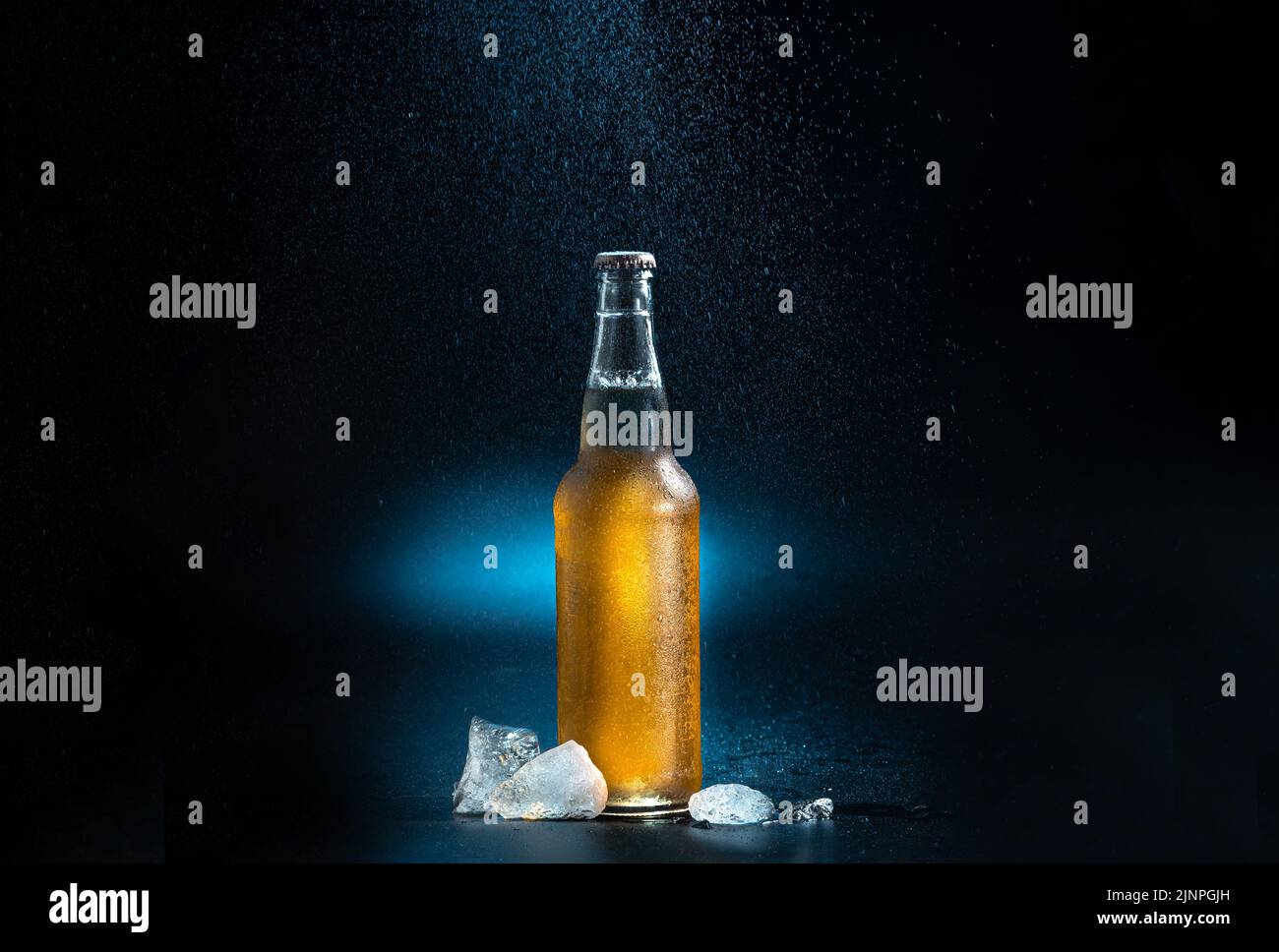beer bottle, splashing drops on a black and blue background. A beer