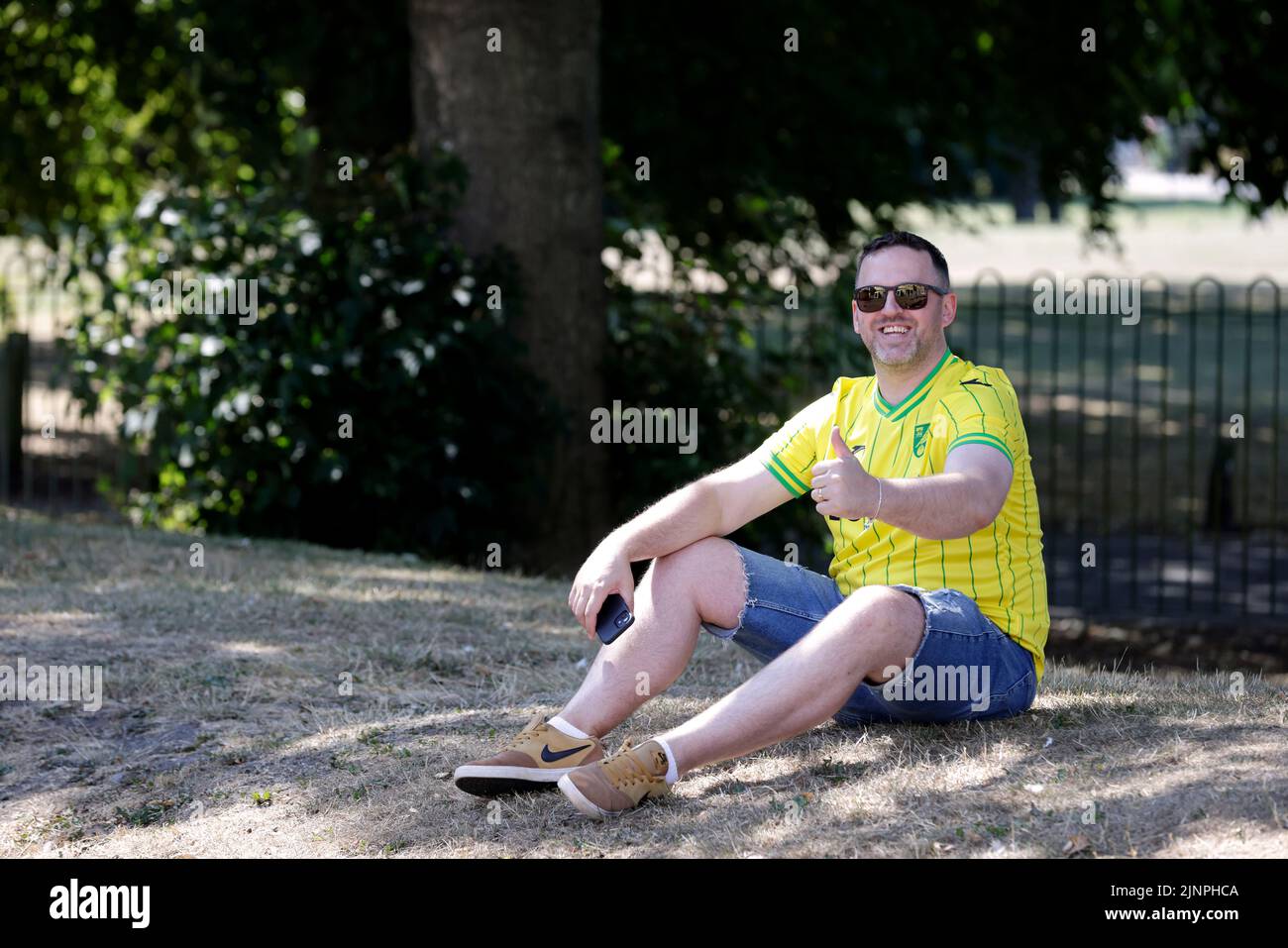 A Norwich City fan outside the ground ahead of the Sky Bet Championship match at the MKM Stadium, Hull. Picture date: Saturday August 13, 2022. Stock Photo