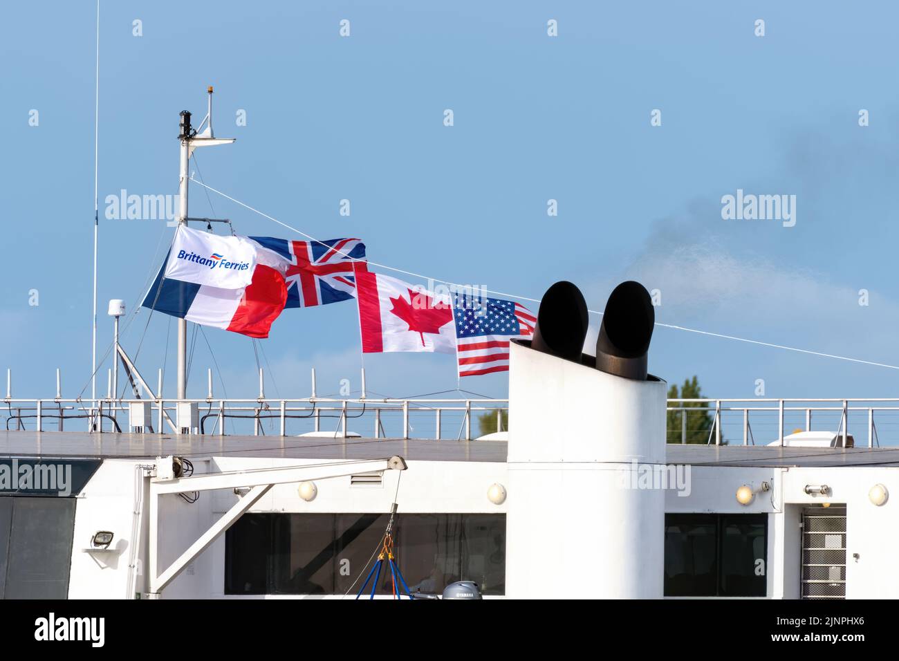 The national flags of France, UK, and USA Canada flying from a French ferry to mark the 75th anniversary of D-Day - June 2019. Stock Photo
