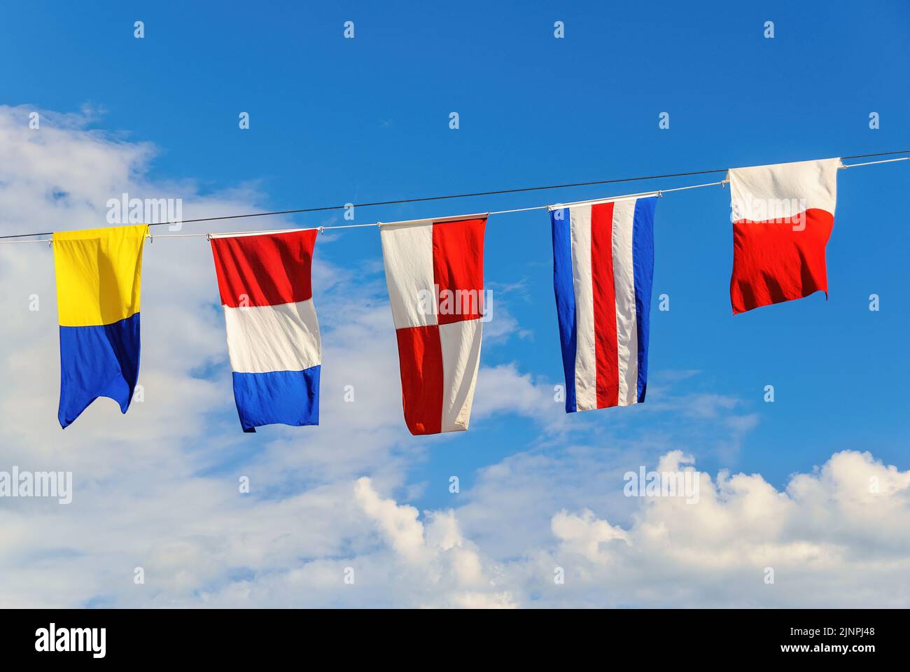 Dress ship is a nautical term for decorating a ship with International Maritime Signal Flags to mark a special occasion. Stock Photo