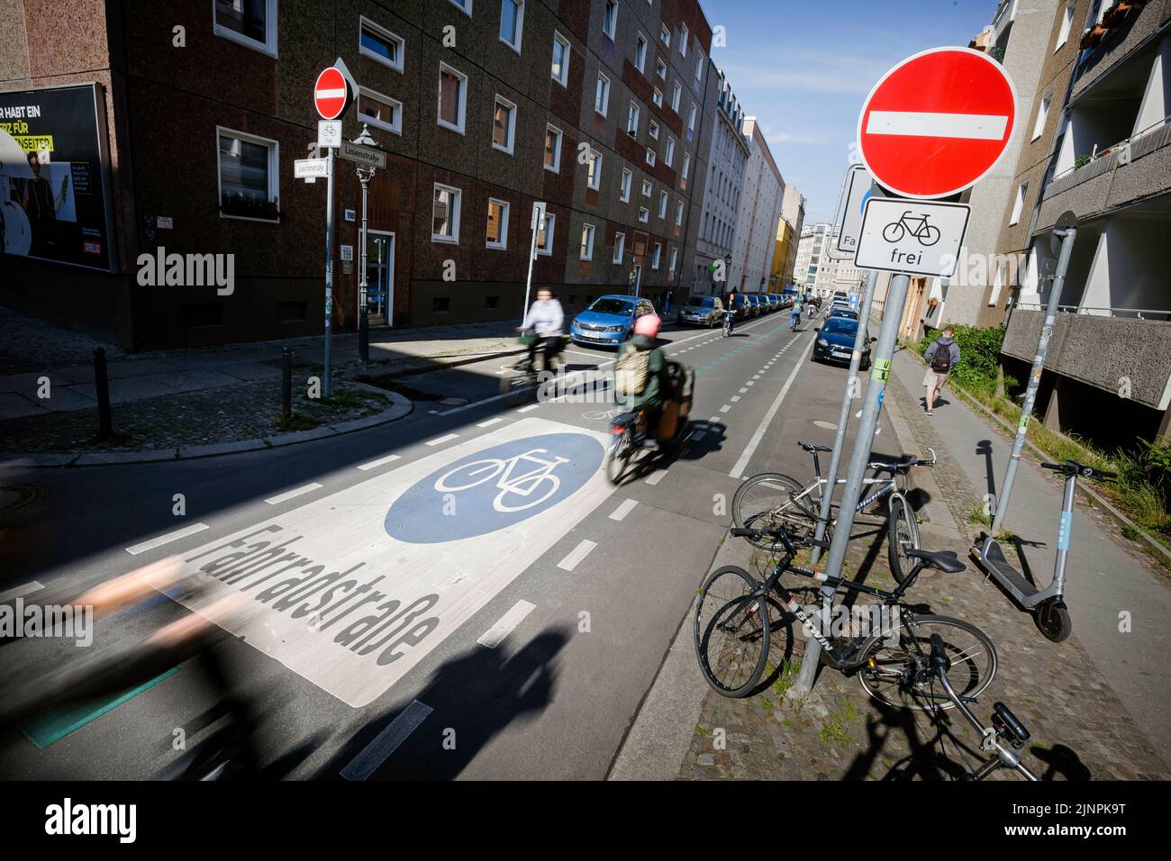 Symbolic photo on the subject of bicycle lanes in the city. Cyclists ride on the Fahrradstrasse in Linienstrasse in Berlin withte. Berlin, May 31, 2022 Stock Photo