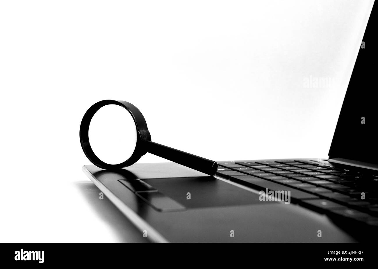Magnifying glass on top of laptop with customizable space for text or