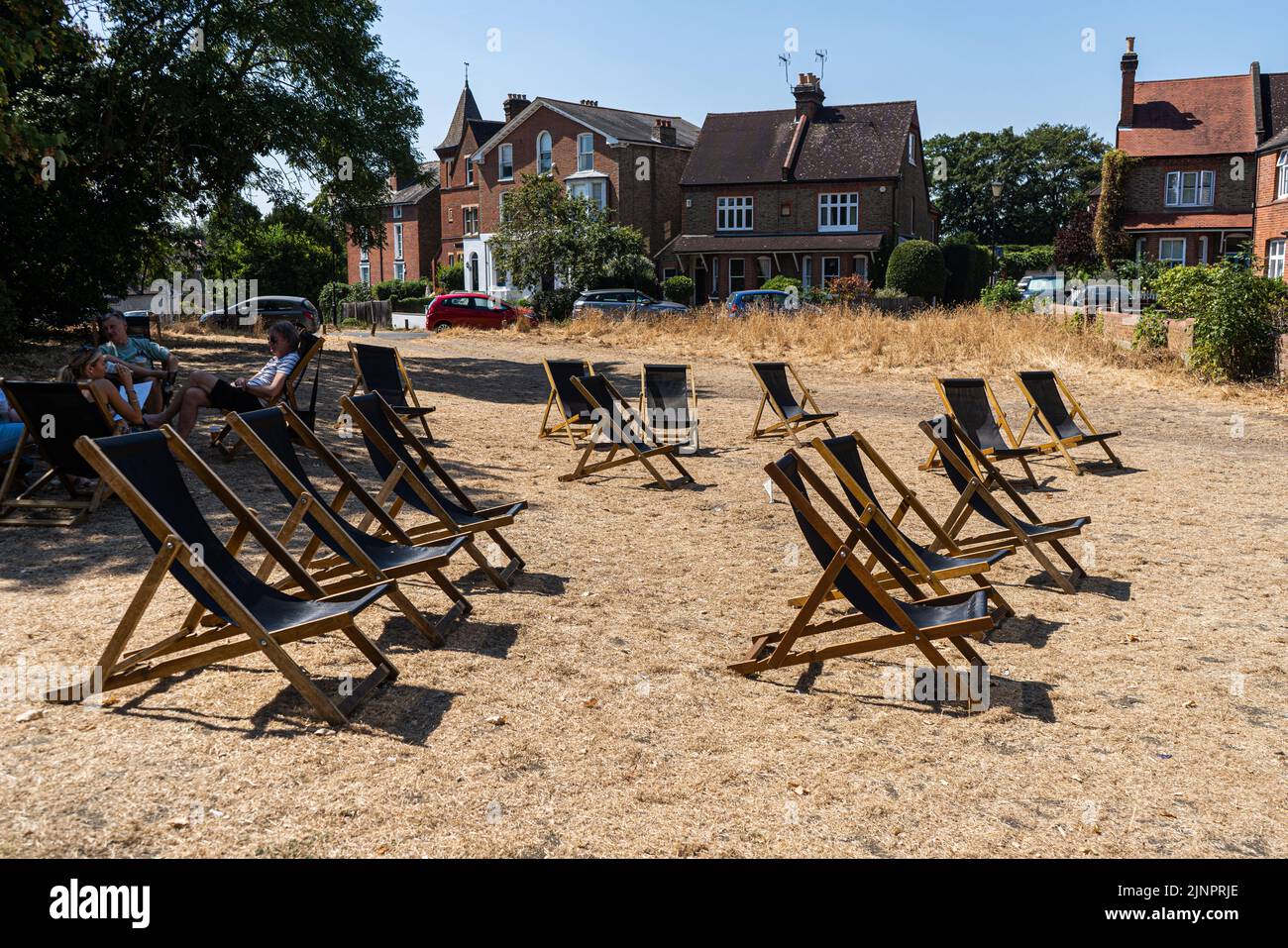 Wimbledon London, UK. 13 August 2022 . Empty deckchairs  on the dried brown grass on  Wimbledon Common . The Met Office has issued an amber extreme heat warning across England and Wales lasting for the rest of the week when temperatures are expected to rise above 30Celsius as the driest spell in England for 46 years continues and a drought has been officially declared by the Environment Agency.Credit. amer ghazzal/Alamy Live News Stock Photo