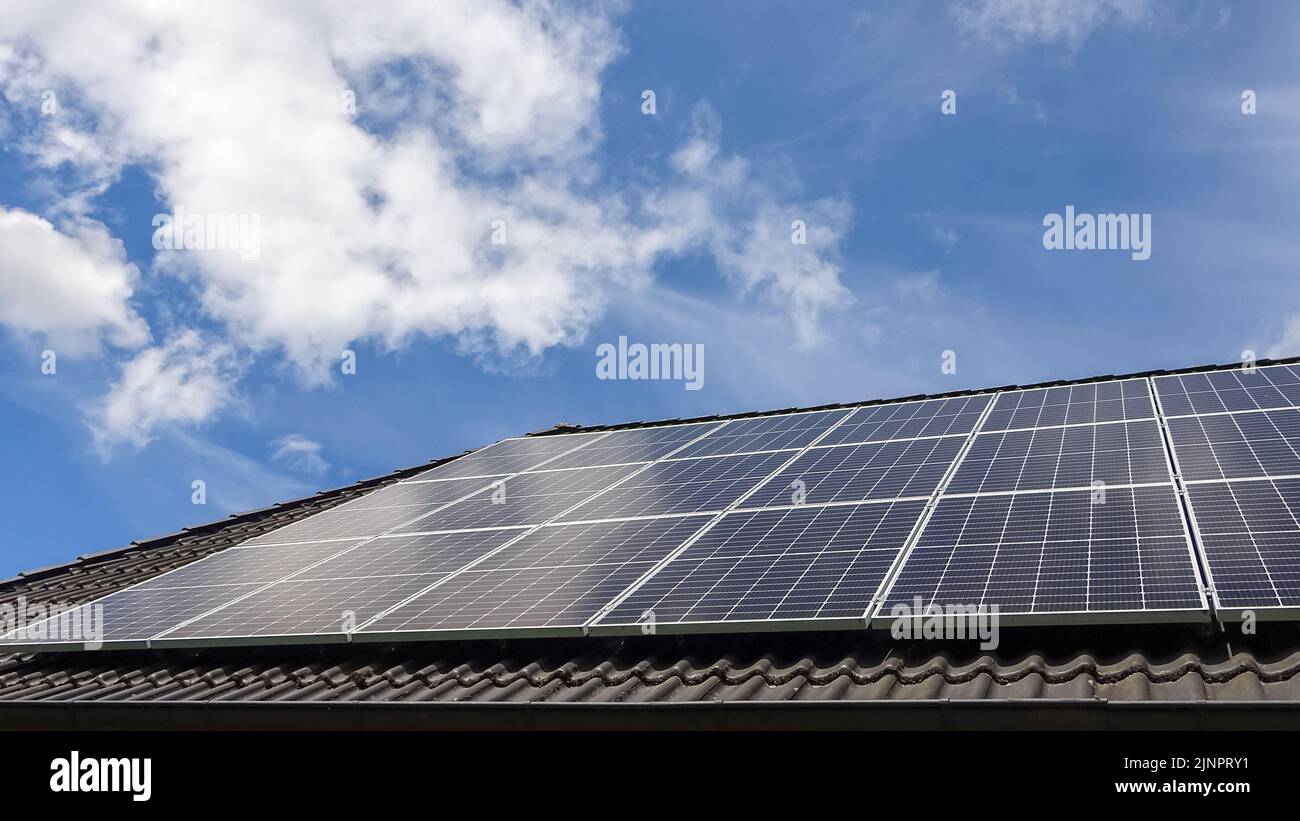 Solar panels producing clean energy on a roof of a residential house ...