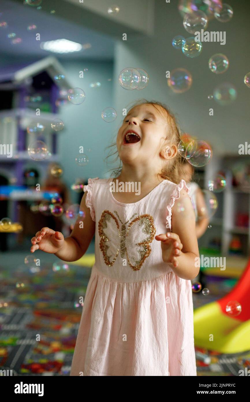 Little Girl Playing With Soap Bubbles Dancing Being In A Good Mood In little-girl-playing-with-soap-bubbles-dancing-being-in-a-good-mood-in