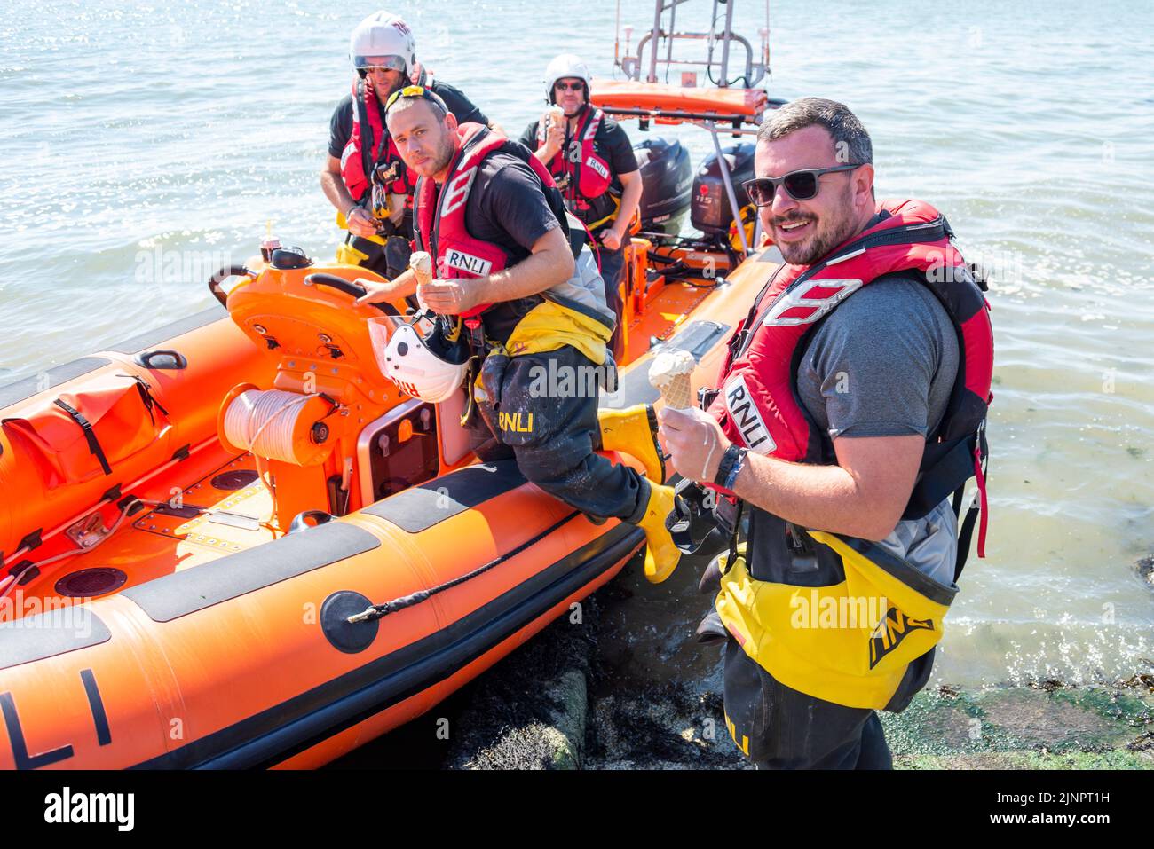 Southend RNLI Lifeboat crew collecting ice creams to cool down whilst patrolling the beaches on a hot August summer day during heatwave Stock Photo