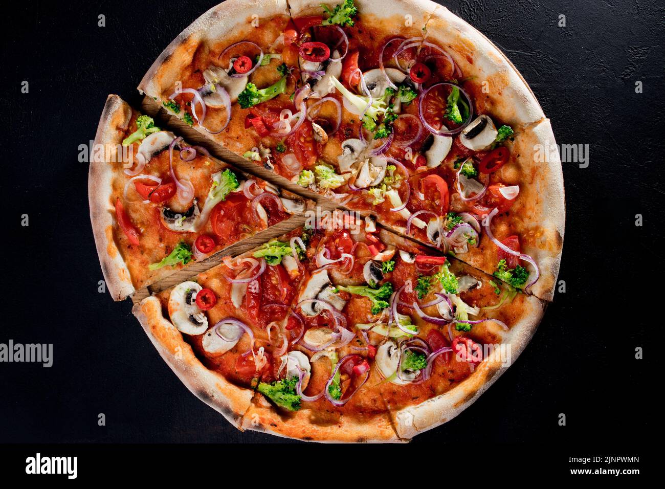 Vegan pizza with tomato sauce, cherry tomatoes, mushrooms, broccoli