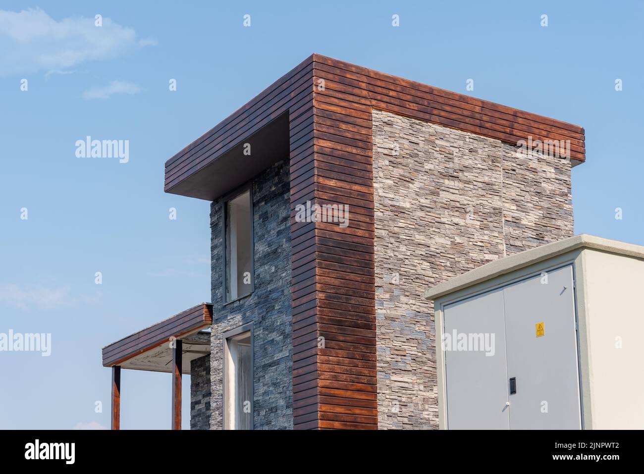 A large outdoor power supply and substation next to a residential building under