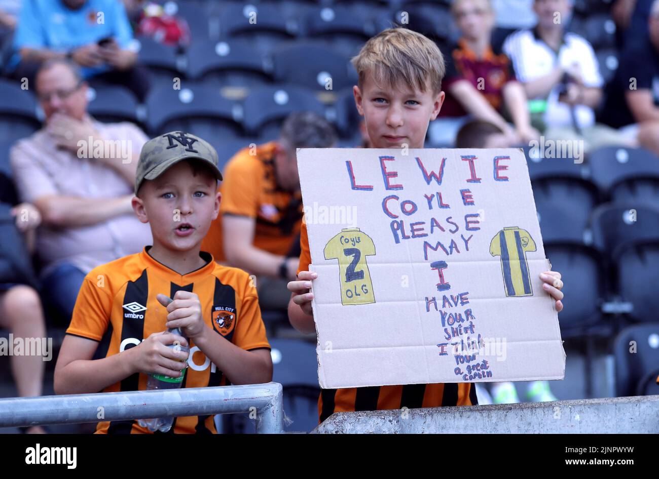 A young Hull City fan in the stands with a sign asking for the shirt of Lewis Coyle during the Sky Bet Championship match at the MKM Stadium, Hull. Picture date: Saturday August 13, 2022. Stock Photo
