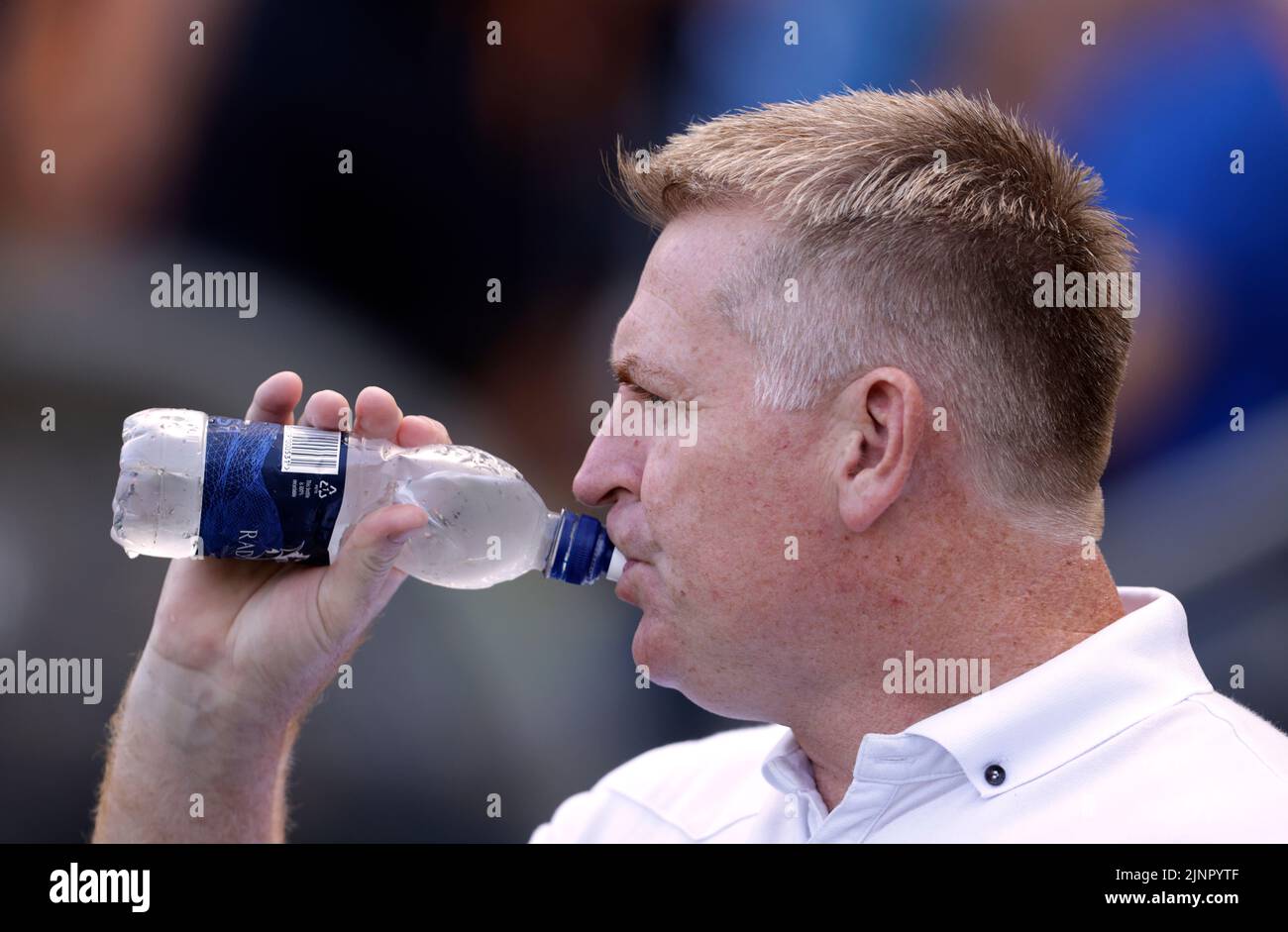 Norwich City manager Dean Smith drinks from a bottle of water during the Sky Bet Championship match at the MKM Stadium, Hull. Picture date: Saturday August 13, 2022. Stock Photo
