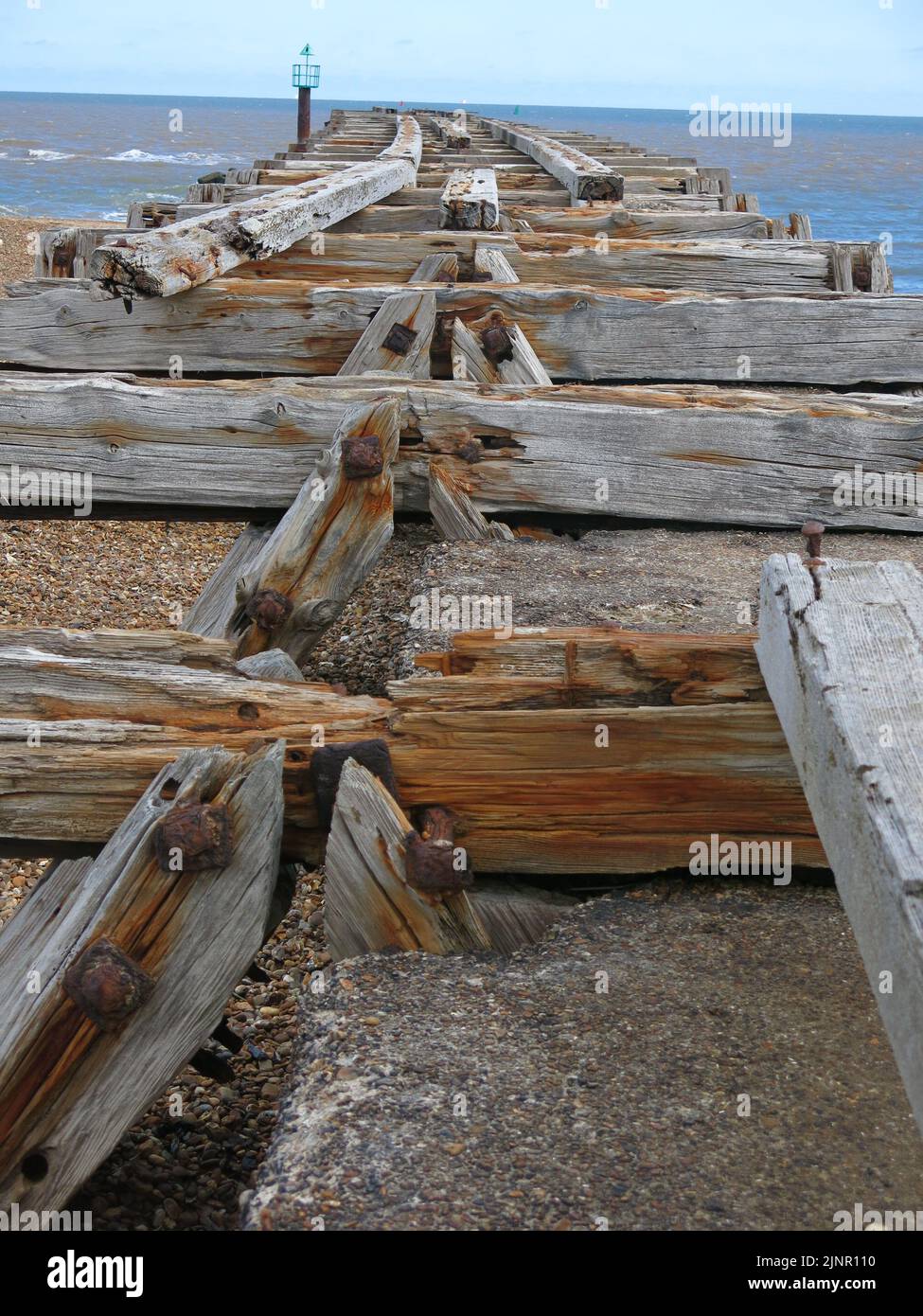 Used to transport sea mines to defend Harwich Harbour, the old wooden planks are all that's left of the railway jetty at Landguard Point, Felixstowe. Stock Photo