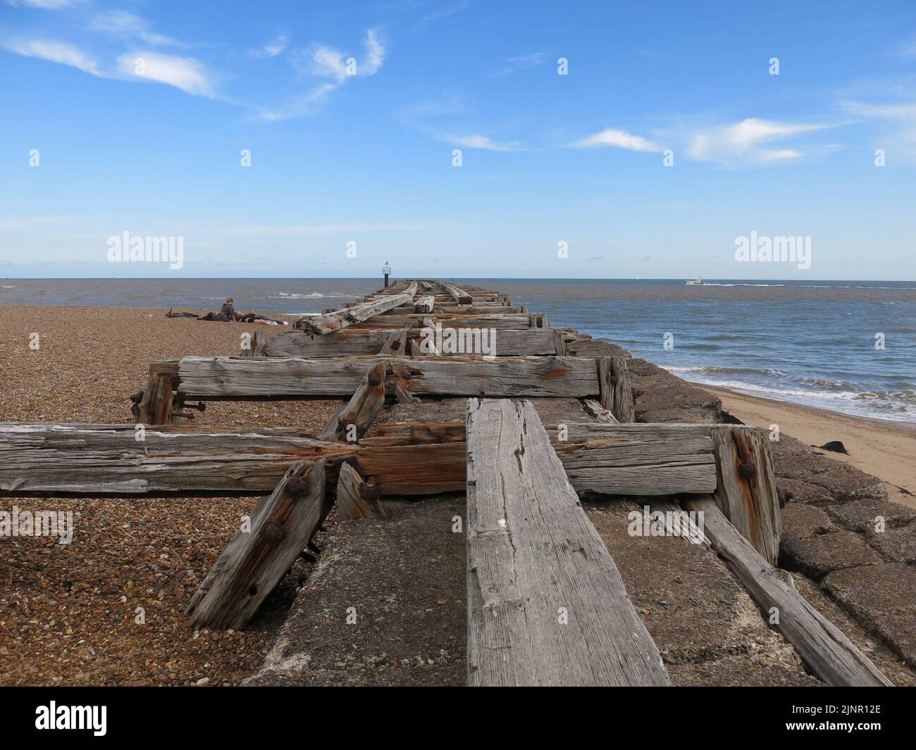 Used to transport sea mines to defend Harwich Harbour, the old wooden planks are all that's left of the railway jetty at Landguard Point, Felixstowe. Stock Photo