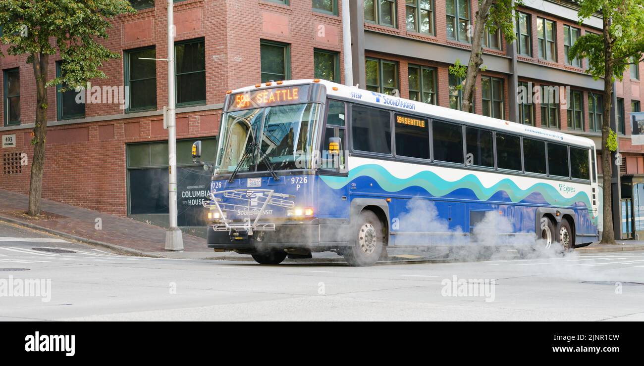 Seattle - August 07, 2022; Sound Transit bus service 594 in downtown Seattle passing a street steam vent Stock Photo