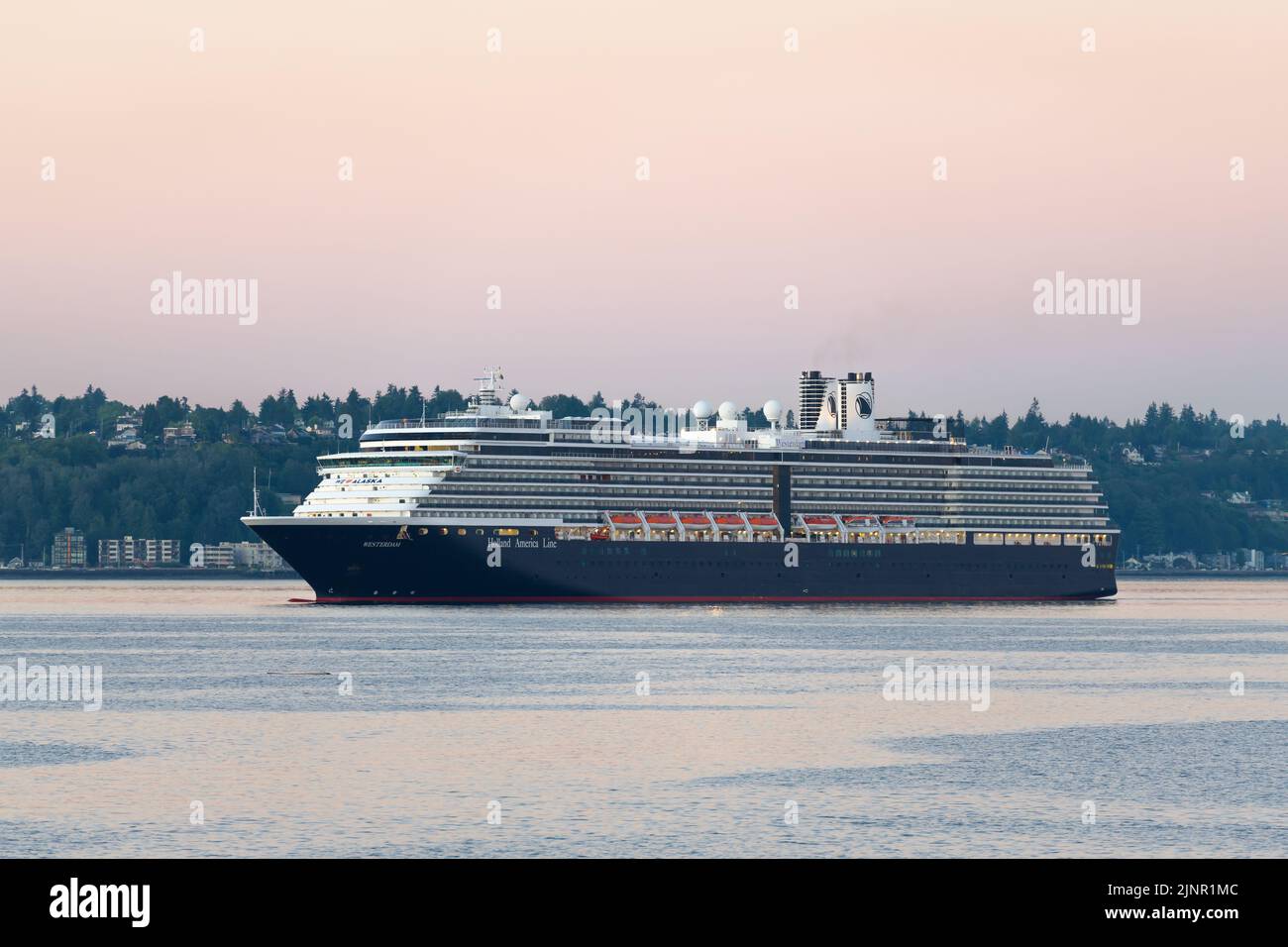 Seattle - August 07, 2022; Holland America cruise ship Westerdam arriving in Seattle in early morning light with calm water in Elliott Bay Stock Photo