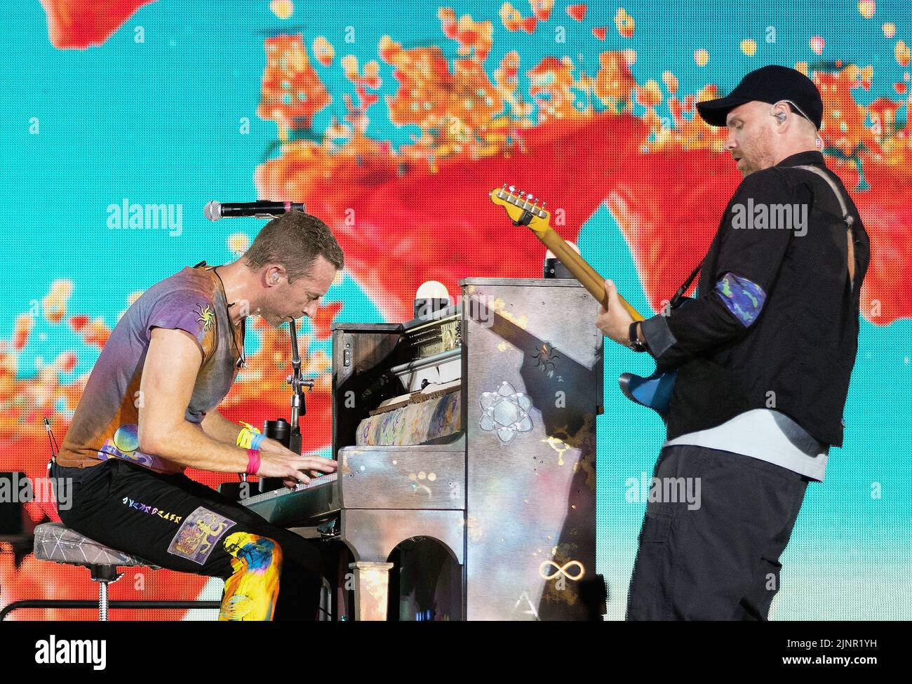 Coldplay band members performing live in the year 2022
